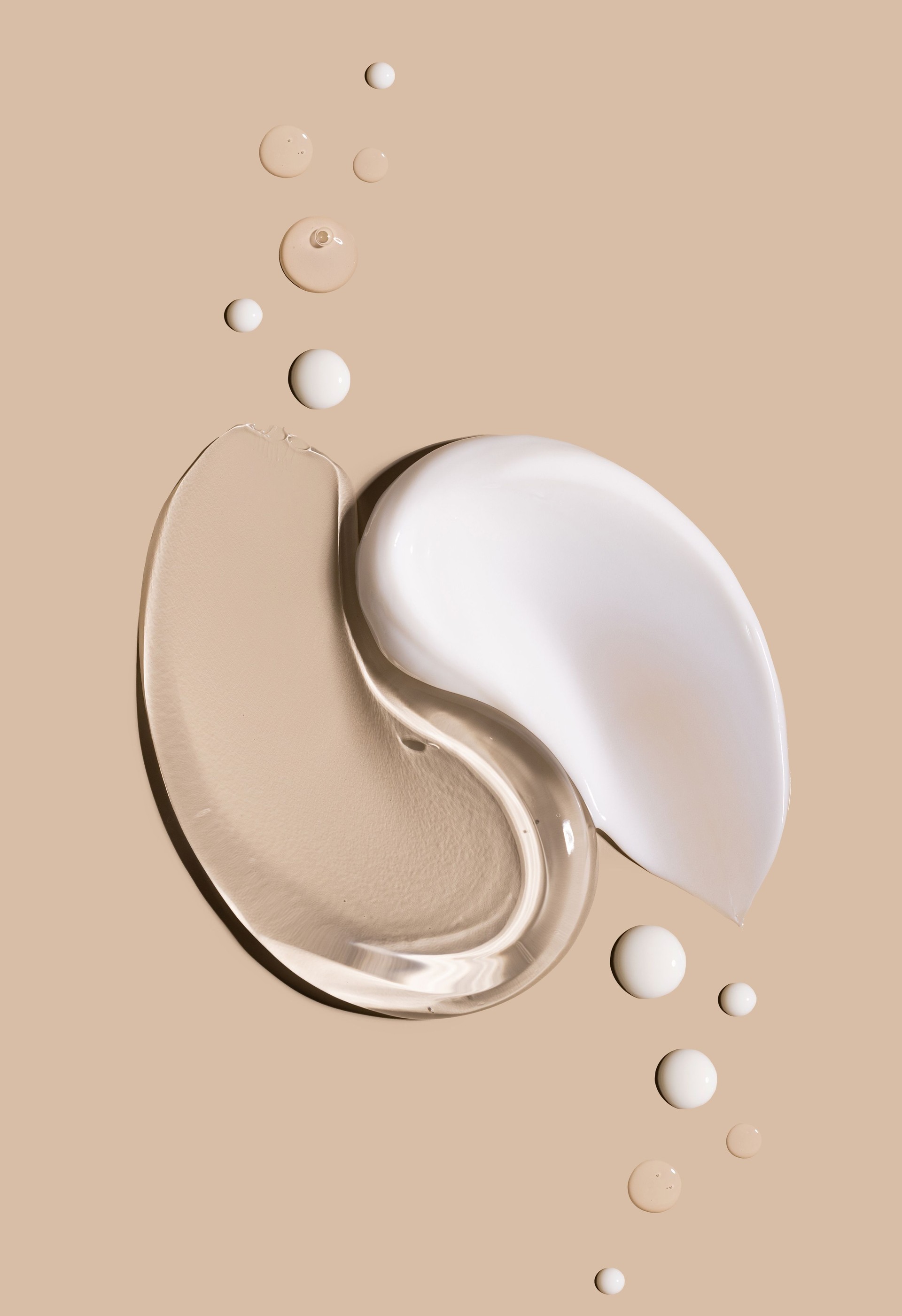 smears of creamy white texture cosmetic sample close up on beige background