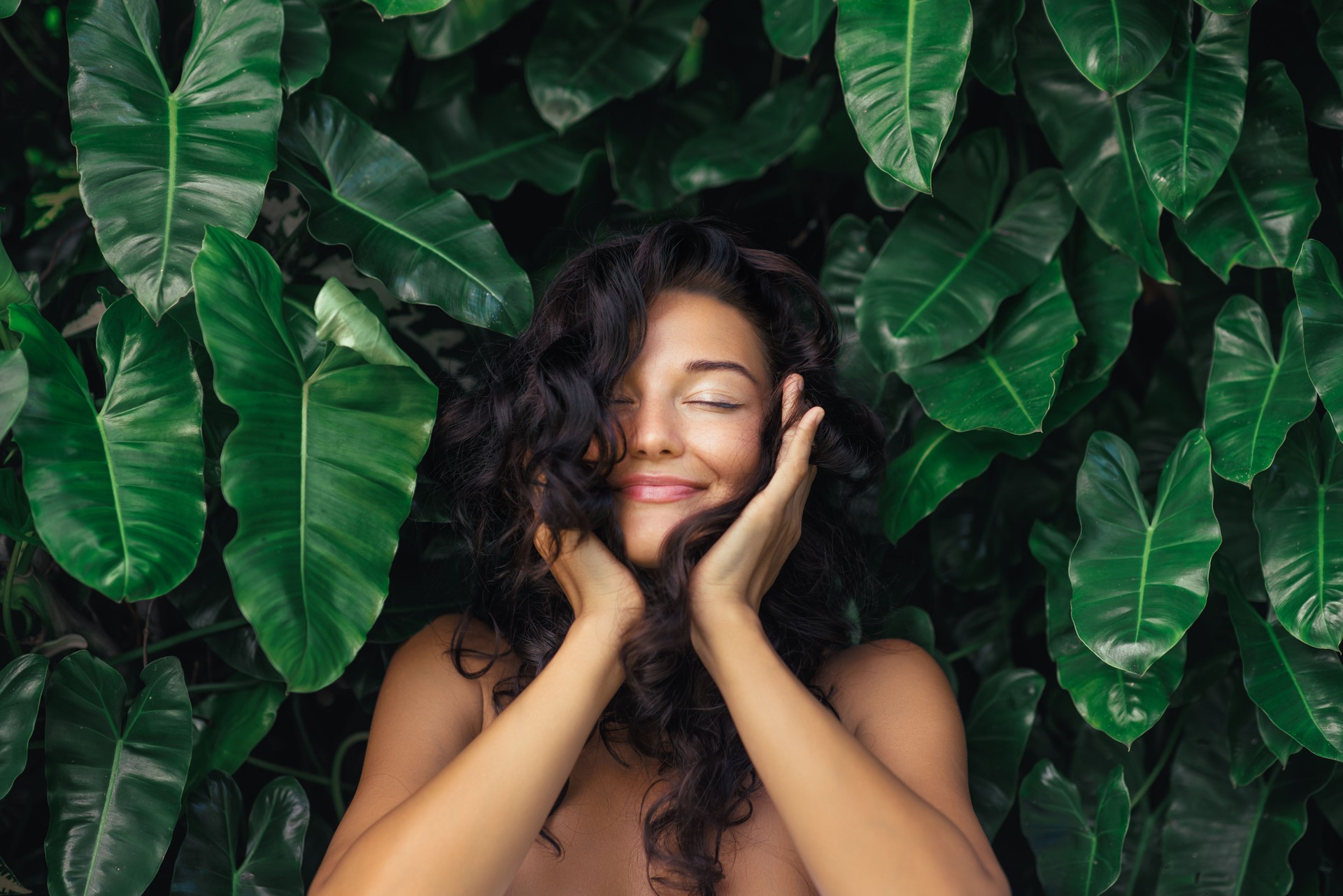 Natural Hair Care Portrait of Young Woman in Exotic Tropical Foliage