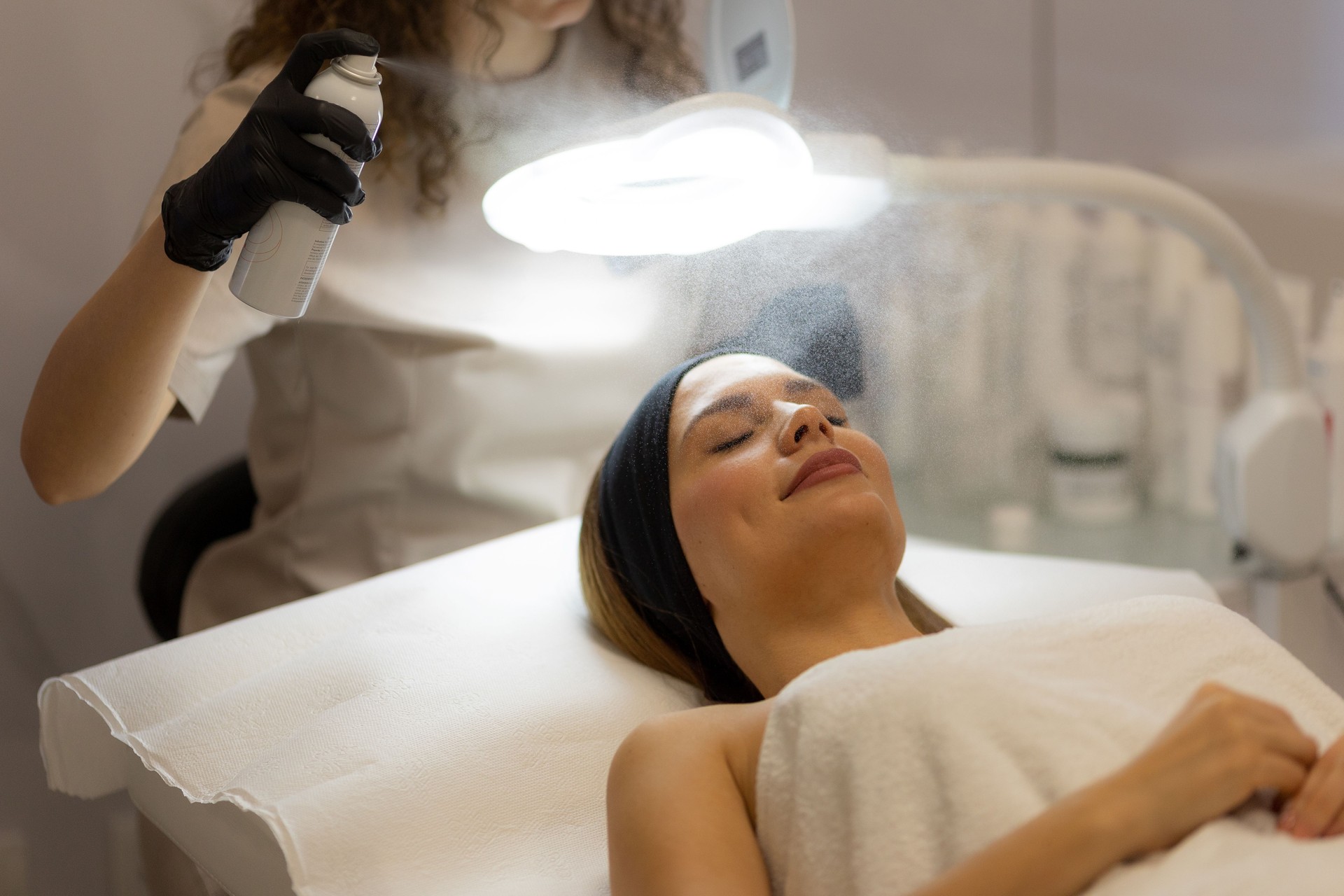 Relaxing facial treatment at a spa with soothing mist and gentle care in a serene environment